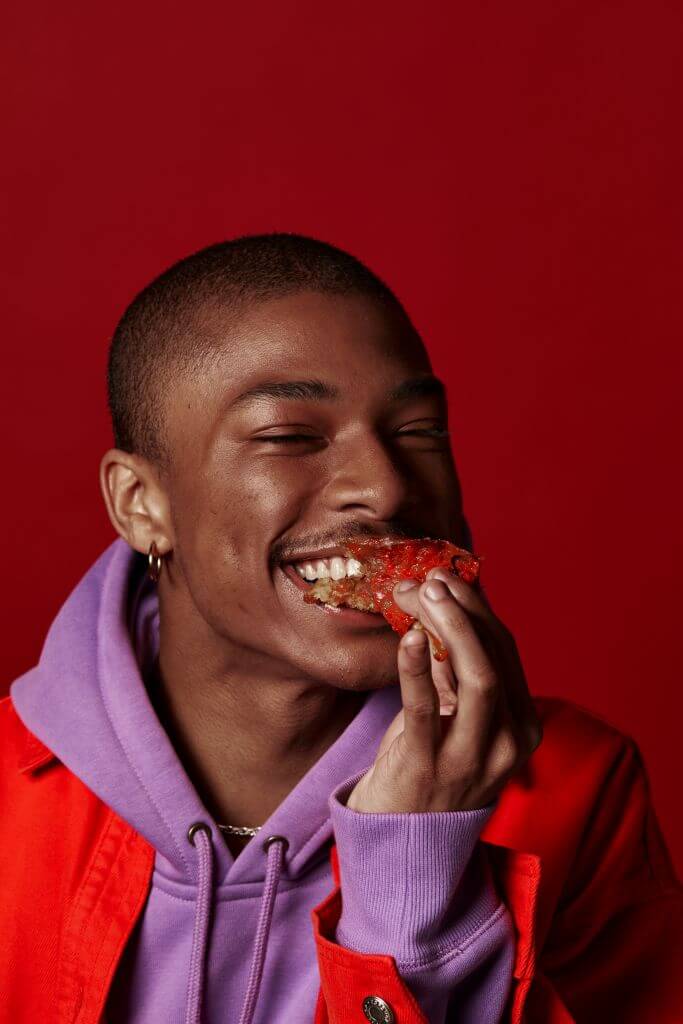 Young person eating a bite of pizza